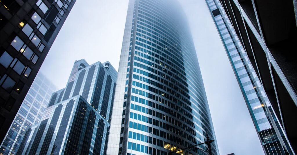 Dramatic view of modern skyscrapers shrouded in fog in an urban cityscape.